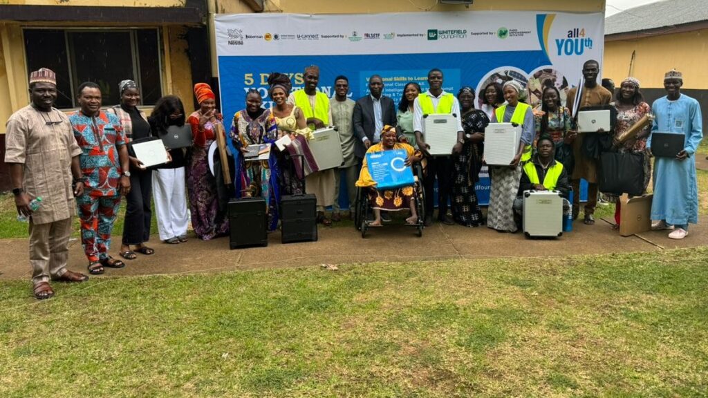 Graduates of the Alliance for Youth Nigeria Vocational Skills Training program proudly showcase their certificates and start-up kits in Jos, Nigeria